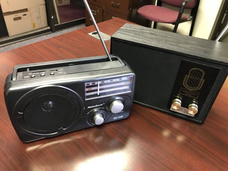 A new AC/DC portable FM/SCA radio sits on a table next to an older table-top AC SCA-only radio