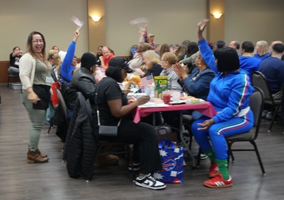 The crowd raising arms for meat tickets