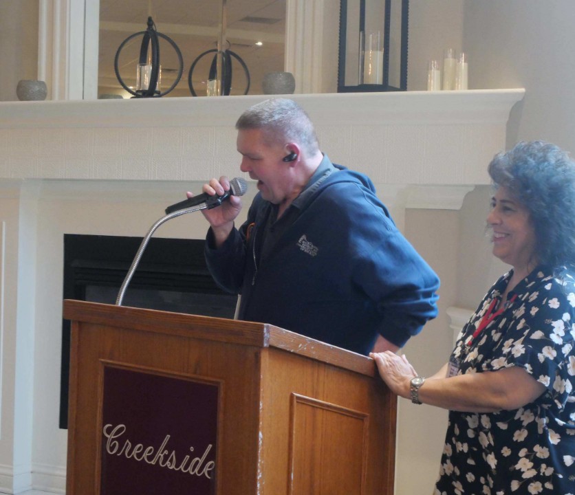 LIstener speaks to the audience as NFRRS' Marian Hetherly stands next to him